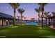 Resort-style pool area with string lights and palm trees at dusk at 1928 W Rowel Rd, Phoenix, AZ 85085