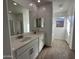 Bathroom with double vanity and large mirror at 22859 E Lords Way, Queen Creek, AZ 85142