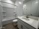 Clean bathroom with a shower-tub combination, white vanity, and wood-look tile flooring at 22859 E Lords Way, Queen Creek, AZ 85142