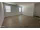 A bright bedroom featuring tile flooring, fresh white walls, and two windows with blinds for natural light at 22859 E Lords Way, Queen Creek, AZ 85142