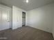 Bright bedroom featuring neutral carpeting and a large closet at 22859 E Lords Way, Queen Creek, AZ 85142