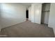 Well-lit bedroom with neutral carpeting and closet at 22859 E Lords Way, Queen Creek, AZ 85142