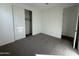 Well-lit bedroom with carpet floors and closet at 22859 E Lords Way, Queen Creek, AZ 85142