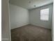 Neutral bedroom with carpet, a single window with blinds, and freshly painted white walls at 22859 E Lords Way, Queen Creek, AZ 85142