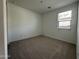 Spacious bedroom with neutral carpeting and window at 22859 E Lords Way, Queen Creek, AZ 85142