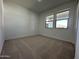 Spacious bedroom with neutral carpeting and large windows at 22859 E Lords Way, Queen Creek, AZ 85142