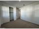 Well-lit bedroom with neutral carpeting and a large closet at 22859 E Lords Way, Queen Creek, AZ 85142