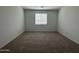 Carpeted bedroom with a window providing natural light at 22859 E Lords Way, Queen Creek, AZ 85142