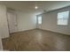 A bright bedroom featuring tile flooring, fresh white walls, and three windows with blinds for natural light at 22859 E Lords Way, Queen Creek, AZ 85142