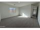 Spacious bedroom with carpeted flooring and large window at 22859 E Lords Way, Queen Creek, AZ 85142