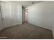 Bedroom featuring a large closet with sliding doors, neutral carpet, and white walls at 22859 E Lords Way, Queen Creek, AZ 85142