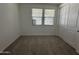 Bedroom featuring a large window, neutral carpet, and a closet with sliding doors at 22859 E Lords Way, Queen Creek, AZ 85142