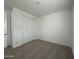 Bedroom featuring a sliding door closet, neutral carpet, and a white painted walls at 22859 E Lords Way, Queen Creek, AZ 85142