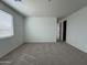 A bright bedroom featuring neutral carpet, fresh white walls, and a window with blinds for natural light at 22859 E Lords Way, Queen Creek, AZ 85142