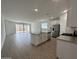 Bright, open kitchen featuring a large island, stainless steel appliances, and sleek white cabinetry at 22859 E Lords Way, Queen Creek, AZ 85142