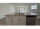 Kitchen island with sink, dishwasher, and ample counter space at 22859 E Lords Way, Queen Creek, AZ 85142