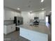 Modern kitchen with stainless steel appliances and an island at 22859 E Lords Way, Queen Creek, AZ 85142