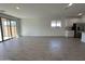 Spacious living room with tile flooring and sliding glass doors at 22859 E Lords Way, Queen Creek, AZ 85142