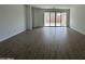 Spacious living room with modern flooring and a sliding glass door leading to the outdoor space at 22859 E Lords Way, Queen Creek, AZ 85142