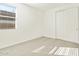 Well-lit bedroom featuring carpet and sliding door closet at 24 S 175Th Ave, Goodyear, AZ 85338