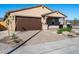 Charming house with a two-car garage, stone accents, and neatly landscaped yard at 24 S 175Th Ave, Goodyear, AZ 85338