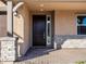 Inviting front entrance with a dark brown door and stone pillars at 24 S 175Th Ave, Goodyear, AZ 85338