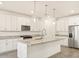 Modern kitchen with white cabinets, granite counters, and stainless steel appliances at 24 S 175Th Ave, Goodyear, AZ 85338