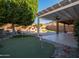 Backyard with putting green, covered patio, and pool at 2602 W Trapanotto Rd, Phoenix, AZ 85086