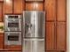 Stainless steel appliances and rich wood cabinets feature in this kitchen at 2602 W Trapanotto Rd, Phoenix, AZ 85086