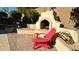 Brick patio with fireplace and red chair at 2602 W Trapanotto Rd, Phoenix, AZ 85086