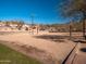 Outdoor sand volleyball court with net and lights at 2602 W Trapanotto Rd, Phoenix, AZ 85086