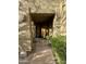 Inviting entryway with a wooden door and lush landscaping at 28414 N 101St Pl, Scottsdale, AZ 85262