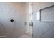 Walk-in shower with marble tile and glass enclosure at 29456 N 208Th Ln, Wittmann, AZ 85361