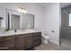 Modern bathroom with a large vanity, walk-in shower, and tile flooring at 29456 N 208Th Ln, Wittmann, AZ 85361