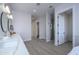 Modern bathroom with double vanity and walk-in shower at 29456 N 208Th Ln, Wittmann, AZ 85361