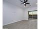 Bright bedroom with wood-look floors and sliding glass door to patio at 29456 N 208Th Ln, Wittmann, AZ 85361