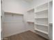 Large walk-in closet with shelves and hanging rods at 29456 N 208Th Ln, Wittmann, AZ 85361