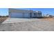 Large concrete driveway leading to a beautiful three-car garage home at 29456 N 208Th Ln, Wittmann, AZ 85361