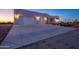 Large concrete driveway leading to a beautiful three-car garage home at 29456 N 208Th Ln, Wittmann, AZ 85361