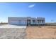 Modern three-car garage home with desert landscaping at 29456 N 208Th Ln, Wittmann, AZ 85361