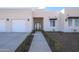 Modern home's front entry with walkway and two-car garage at 29456 N 208Th Ln, Wittmann, AZ 85361