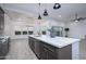 Modern kitchen island with white quartz countertop and gold accents at 29456 N 208Th Ln, Wittmann, AZ 85361