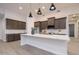 Modern kitchen with dark cabinets and large island at 29456 N 208Th Ln, Wittmann, AZ 85361