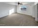 Bright bedroom featuring a large window and ceiling fan at 31027 W Bellview St, Buckeye, AZ 85396