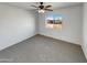 Bedroom with large window and ceiling fan at 31027 W Bellview St, Buckeye, AZ 85396