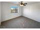 Bedroom with ceiling fan and neutral carpeting at 31027 W Bellview St, Buckeye, AZ 85396