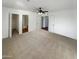 Large main bedroom with neutral carpeting, walk-in closet, and bathroom access at 31027 W Bellview St, Buckeye, AZ 85396