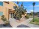 Tan two-story condo with a tree, walkway, and lamppost at 3511 E Baseline Rd # 1243, Phoenix, AZ 85042