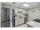 Modern kitchen with stainless steel appliances and white cabinets at 3511 E Baseline Rd # 1243, Phoenix, AZ 85042