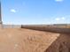 A flat, dirt-filled backyard, ready for landscaping and personalization at 35581 N Thicket Way, San Tan Valley, AZ 85144